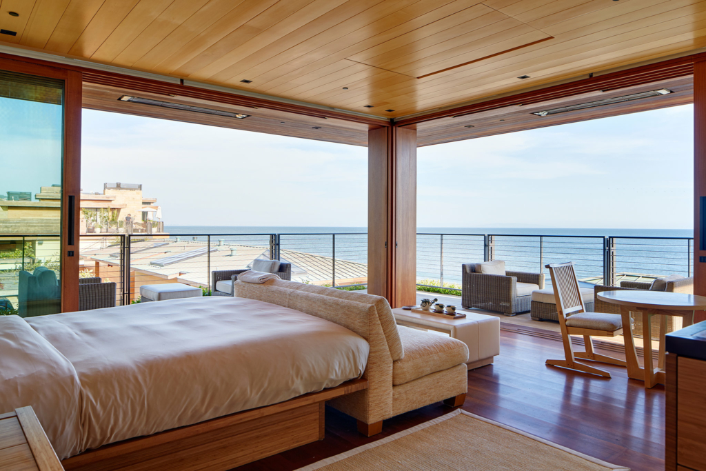 a bedroom with a view of the ocean.