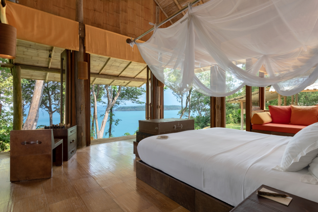 a bedroom with a view of the water.