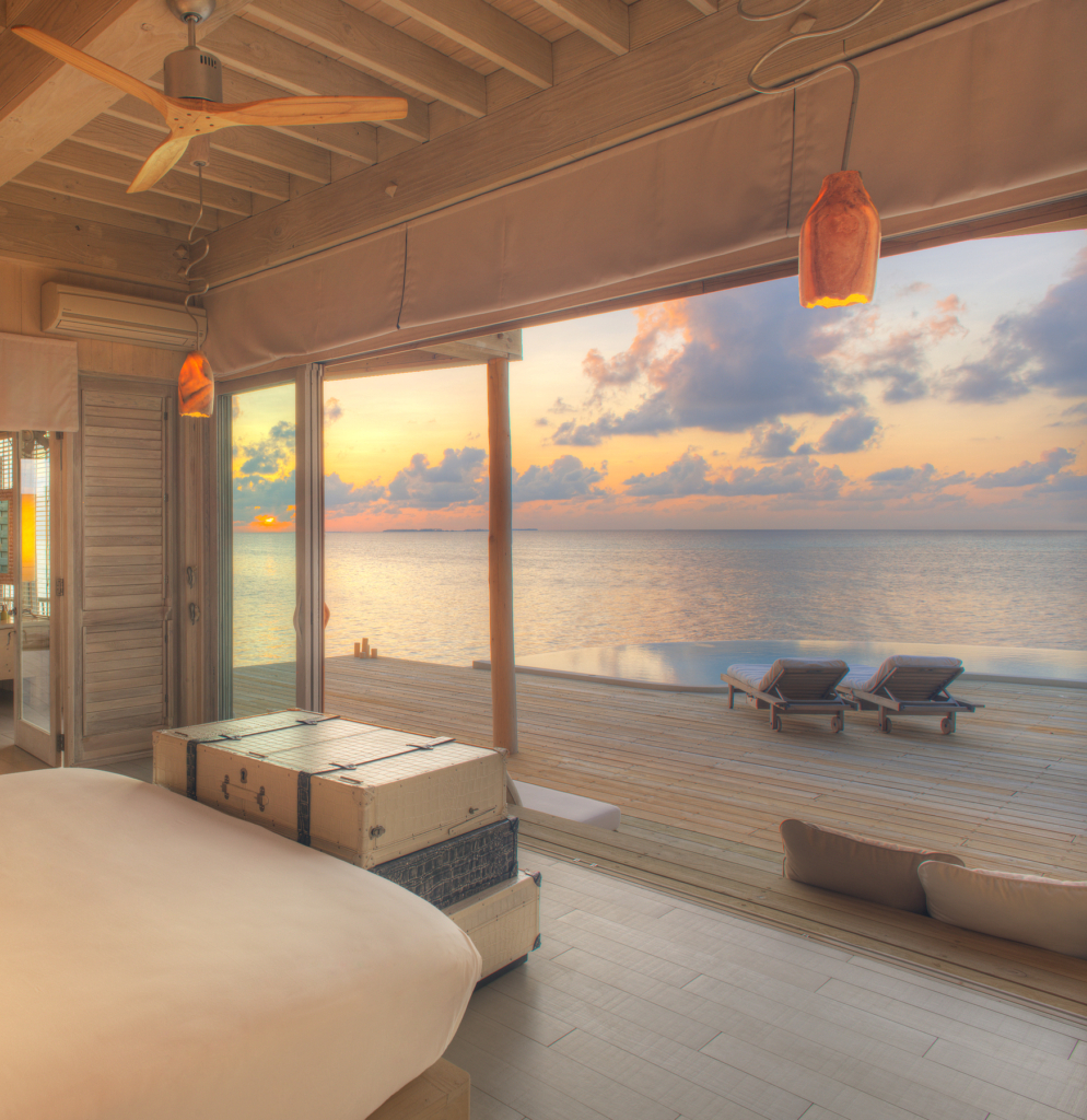 a bedroom with a view of the ocean.