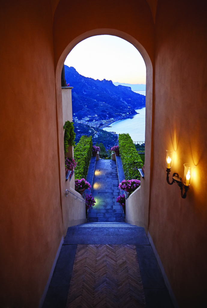 an archway leading to a scenic view of a lake.
