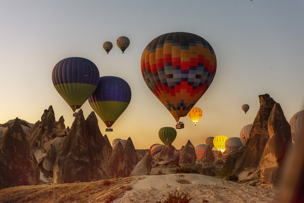 a group of hot air balloons flying in the sky.
