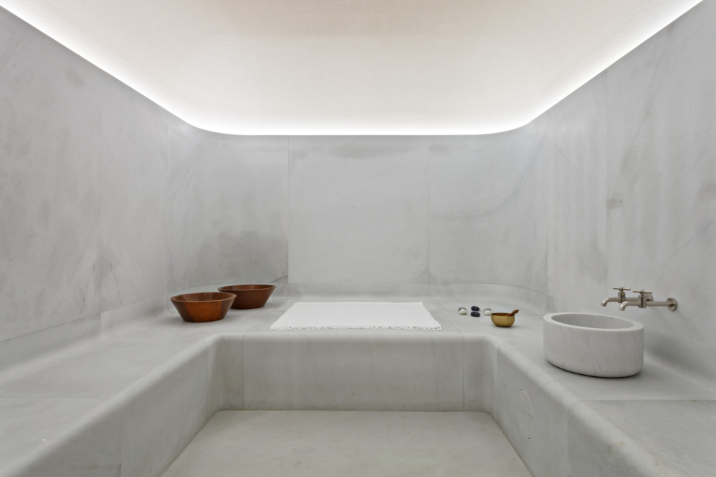 a white bathroom with two sinks and a bathtub.