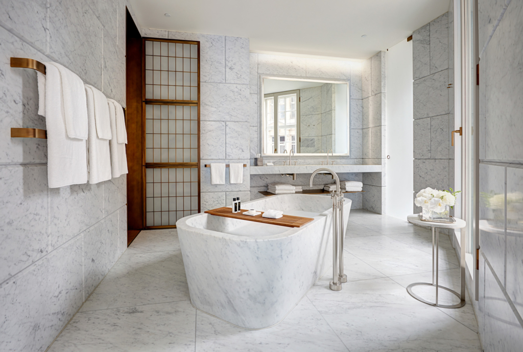 a bathroom with a marble bathtub and sink.