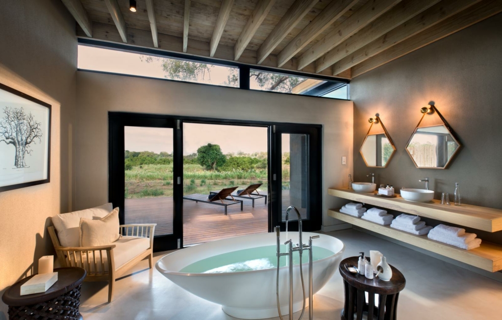 a bathroom with a large tub and a large window.