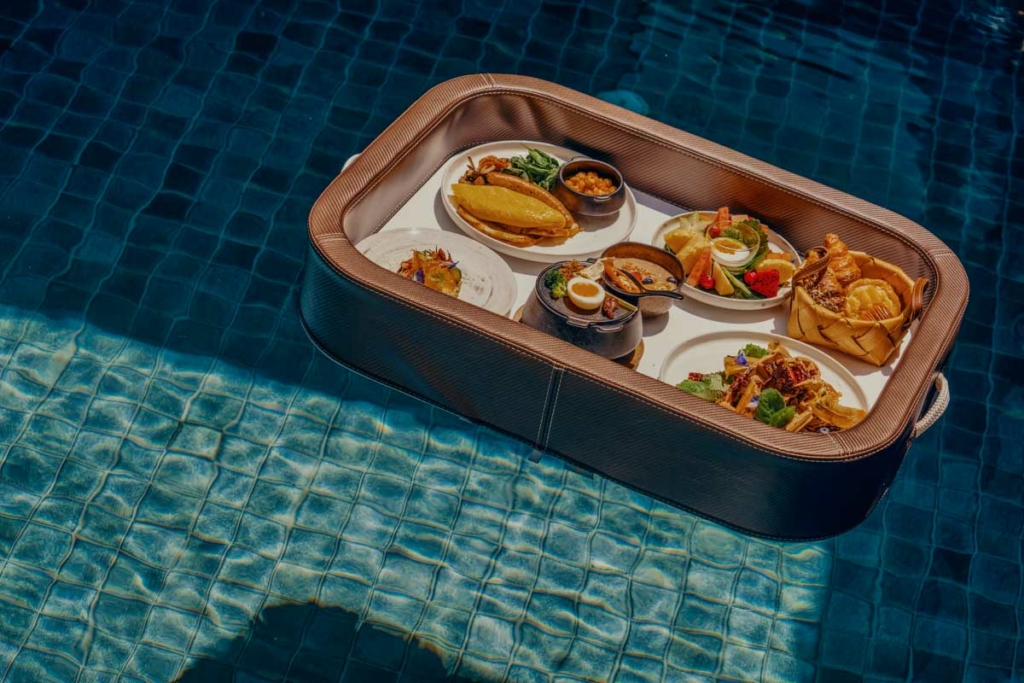 a tray of food sitting on top of a swimming pool.