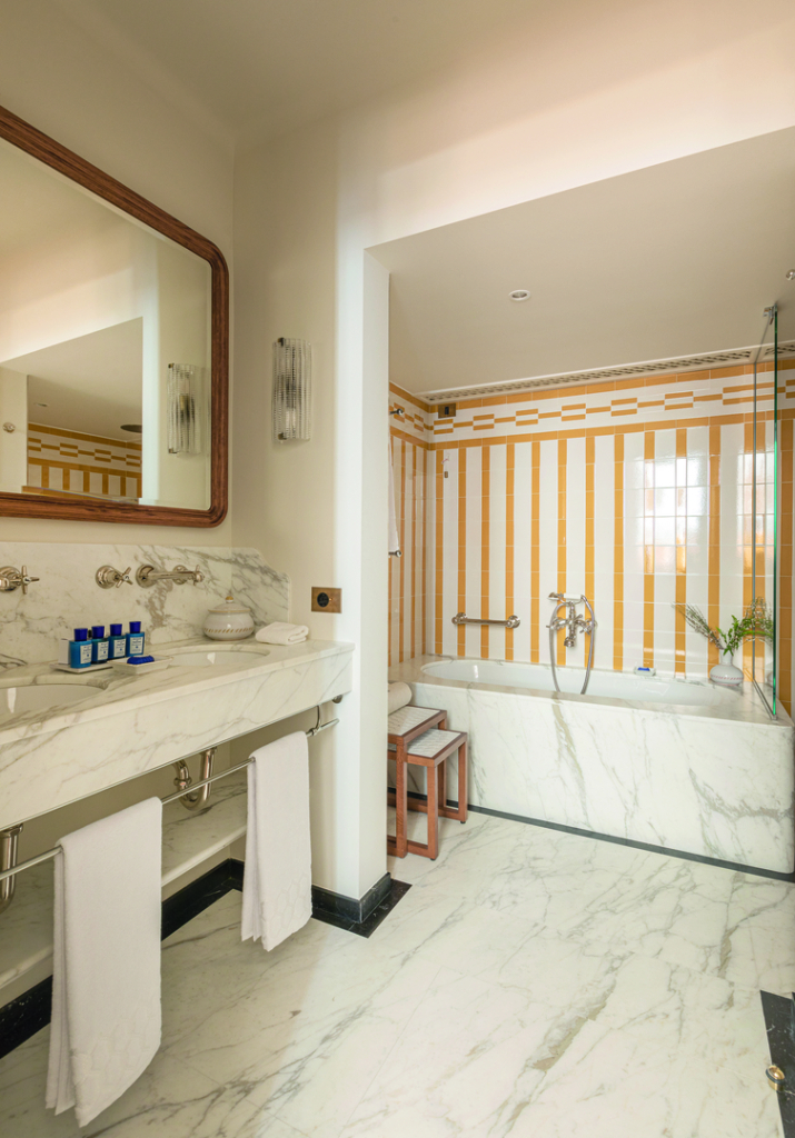 a bathroom with marble counter tops and a large mirror.