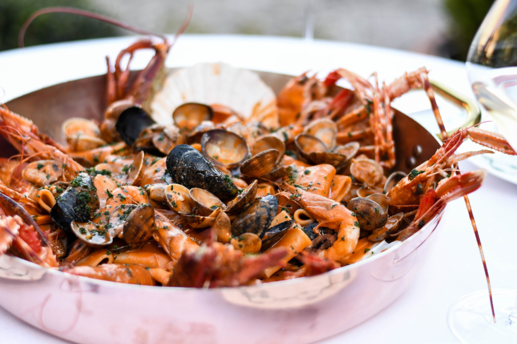 a pan filled with seafood and mussels on a table.